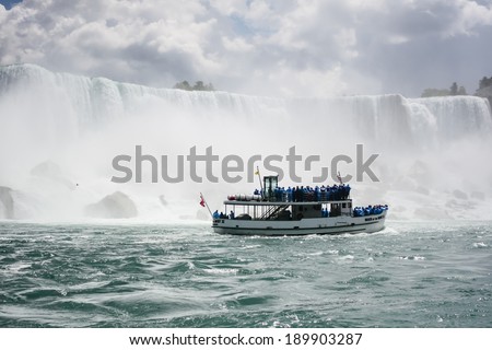 NIAGARA FALLS, USA - JULY 16: Tourists aboard the Maid of the Mist boat take a closer look at the American Falls on July 16, 2009 in Niagara Falls, USA.
