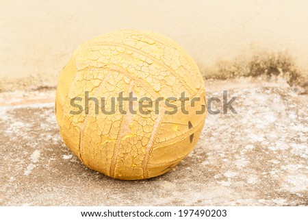 Old Volleyball - An old volley ball on a concrete surface.