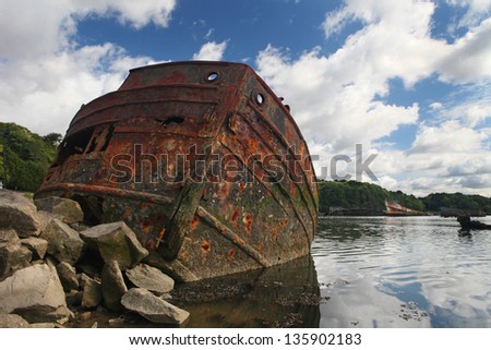 Rusty boat.        Old rusty iron boat stranded and abandoned in Kerhervy, Lorient, Brittany, France