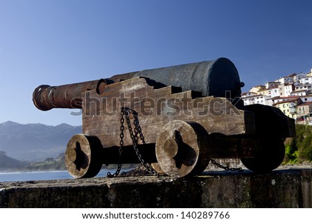 Rusty iron cannon pointing out to sea. Old Cannon.
