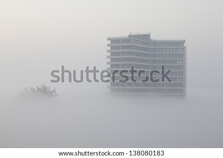 High-rise apartment building sticking out of the fog. Wageningen, the Netherlands