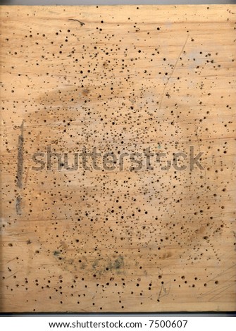 An old piece of scrap wood, used as a working surface in a small carpenter shop. Suitable for a background texture