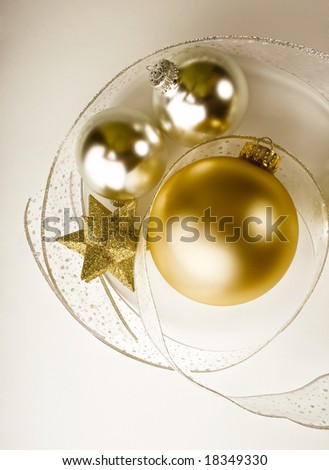 Silver and gold Christmas ornaments, a glittery gold star and fancy ribbon