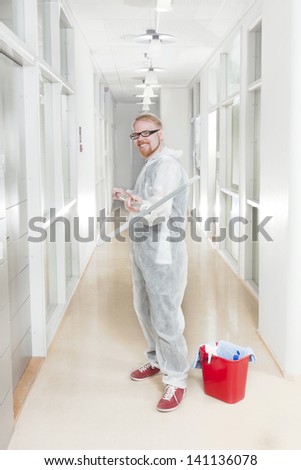 Man in Overall Ready to Clean Office Corridor
