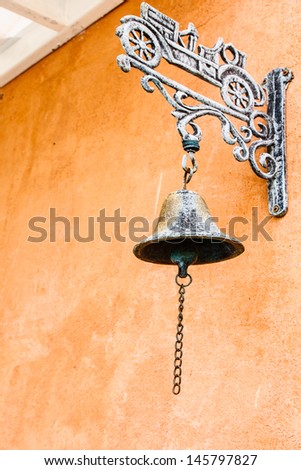 Closeup bronze bell with red wall