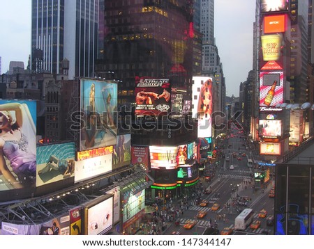 NEW YORK CITY - SEP 29: Lights and advertisements of Times Square at night, September 29, 2006 in New York City. Times Square is  a major center of the world\'s entertainment industry