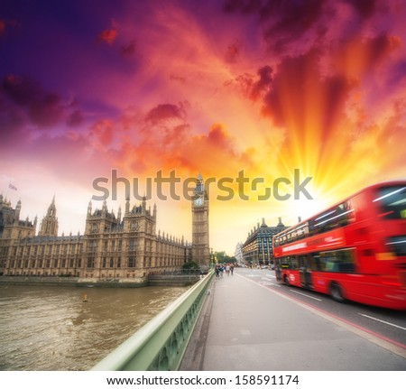 Red Bus crossing Westminster Bridge at sunset - London.