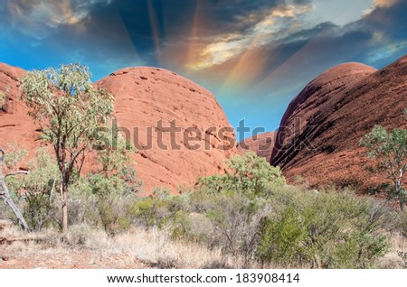 Beautiful rocks of Australian Outback against colourful sky.