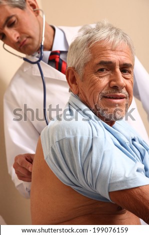 Male doctor examining elder patient at the hospital.