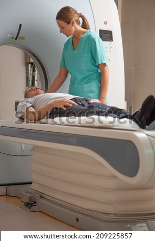 Computed tomography scan with male patient and female doctor.