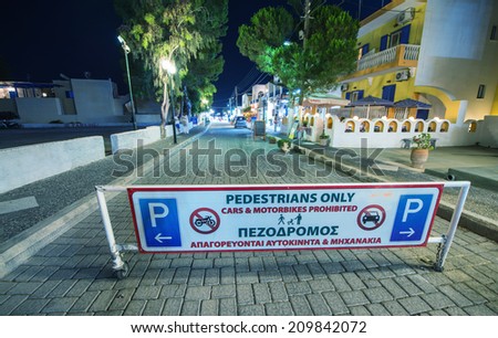SANTORINI, GREECE - MAY 27, 2014: Pedestrian only street sign in Kamari helps tourists visit town. Almost 2 million people visit Santorini each year.