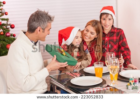 Happy caucasian family celebrating Christmas at the table.