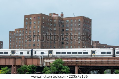 NEW YORK CITY - MAY 25, 2013: Metro North Railroad train speeds up among buidings. It is the busiest commuter railroad in the United States in terms of monthly ridership.