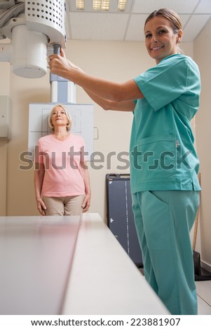 Female doctor with patient at x-ray machine.