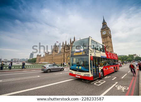 LONDON - AUG 28: Tourist bus crossing Westminster Bridge in the United Kingdom on August 28, 2013 in London. The city is visited by more than 40 million tourists annually.