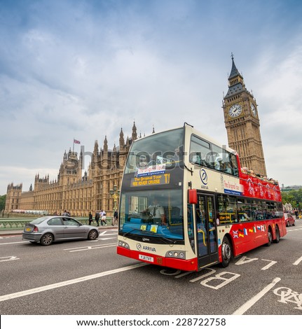 LONDON - AUG 28: Tourist bus crossing Westminster Bridge in the United Kingdom on August 28, 2013 in London. The city is visited by more than 40 million tourists annually.