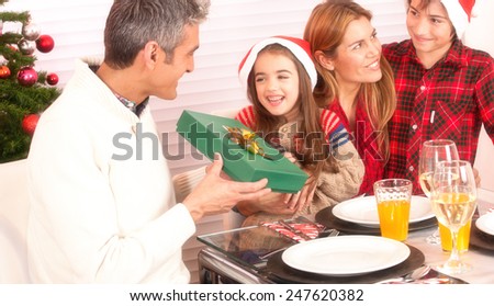 Christmas concept. Happy family at lunch with tree on background.