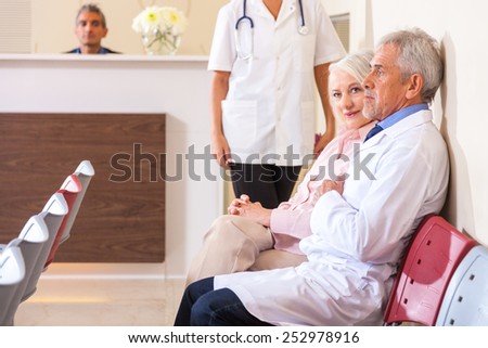 Doctors and patients in hospital waiting room.