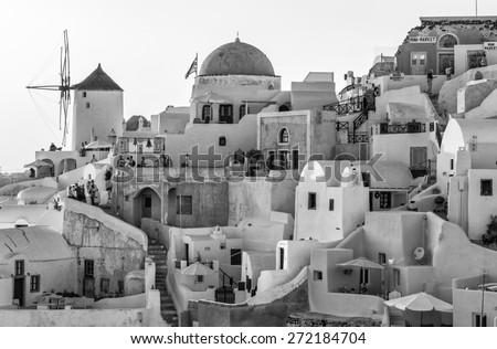 SANTORINI - JULY 11, 2014: People wait for sunset time in Oia town. Santorini is a major tourist destination in Greece.