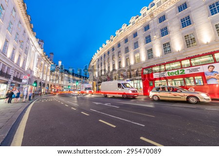 LONDON - JUNE 15, 2015: Buses and traffic in Regent Street at night. London attracts 50 million people across the world.