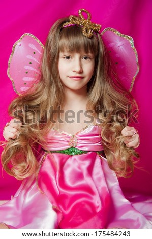 little girl in a pink dress and fairy wings