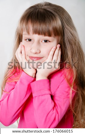 little girl with long hair in a pink blouse