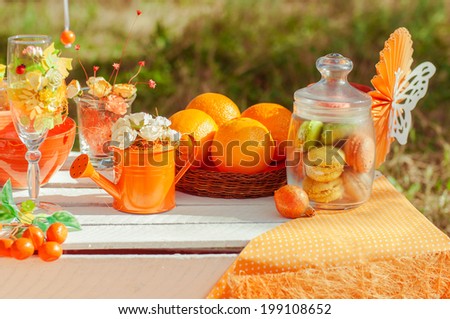 Orange picnic with oranges flowers and glasses of summer