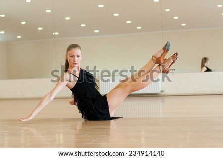 Young girl dancer doing exercises in a dance class