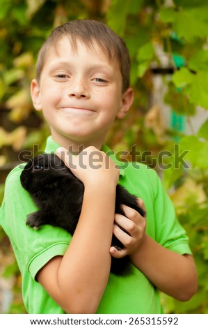 The little boy with a rabbit in the hands of spring