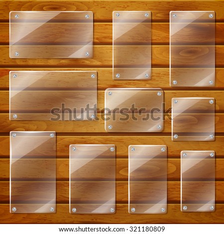 Set of transparent glass plates of different shapes, bolted to wooden planks