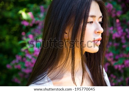 Close-up portrait of beautiful asian young woman resting on nature