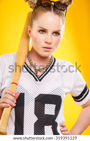 Beautiful pregnant woman in sport style - isolated over a yellow background