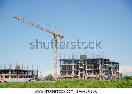 Building tower with tower crane on blue sky day