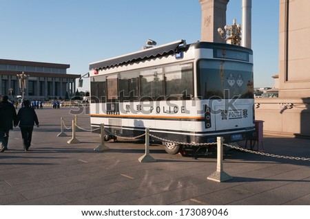 BEIJING, CHINA - DEC 5: Police bus on Tiananmen Square on Dec 5, 2013. Tiananmen Square is the fourth largest city square in the world