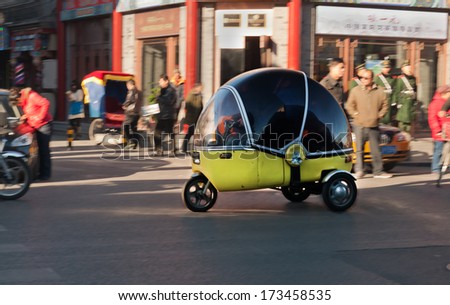 BEIJING, CHINA - DEC 5: Chinese 3 wheel car or motorbike at street  on Dec 5, 2013. It is cheap  mode of transport in China.