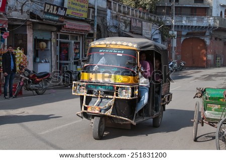 AMRITSAR, INDIA, DEC - 7, 2014:  Auto rickshaw or tuk-tuk on the street. Auto rickshaws are a common means of public transportation in India