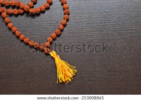 Japa mala on the table. Prayer beads made from the seeds of the rudraksha tree.