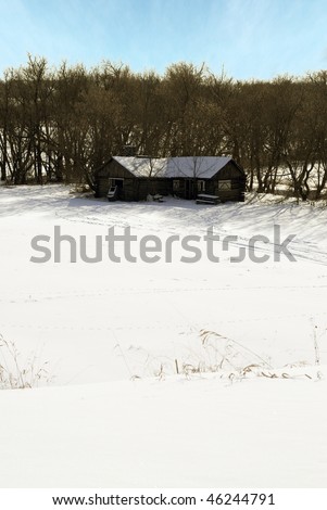 A winter cabin surrounded by trees and snow on a partly cloudy day.