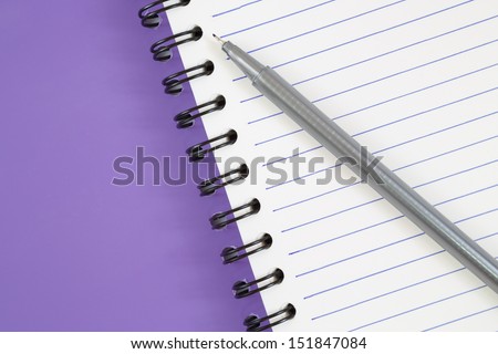 notebook spiral bound and pen on white background