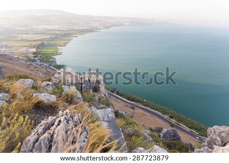 Mountain Arbel stone cliffs above Galilee sea lake road, Israel.