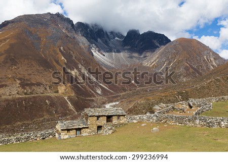 Stone farm house building, Himalaya ridge mountains peaks, Everest Base Camp route trail, Nepal.