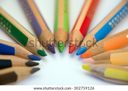 Set of crayons pointing to the center on white background