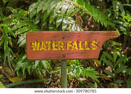 Wooden signpost to the waterfall