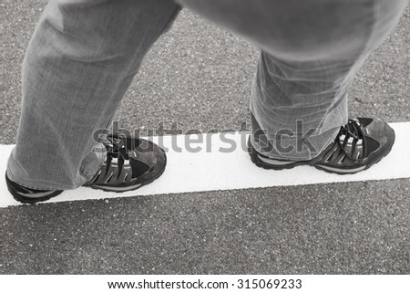 White line on street with walking people