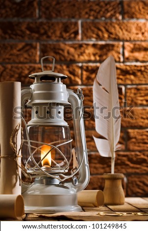 composition of old writing items and kerosene lamp