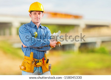a young contractor with tools on construction site
