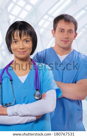 Portrait of medical workers in corridor of modern hospital