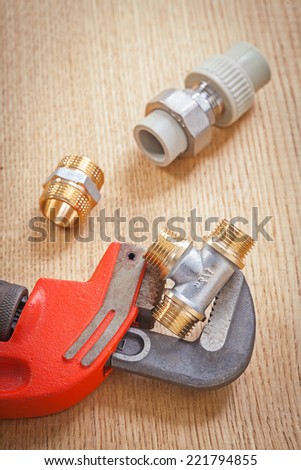 plumbing tools on wooden board