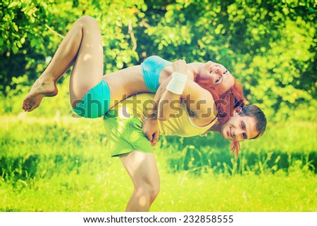 sports couple young man and girl playing in a park field instagram stile