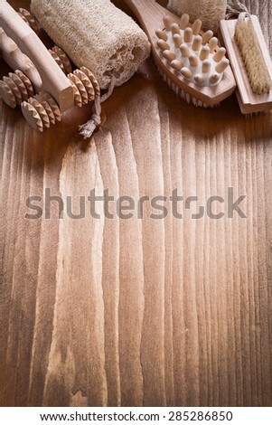 Scrubbing brush loofah and peeling massagers on pine vintage wood board sauna concept